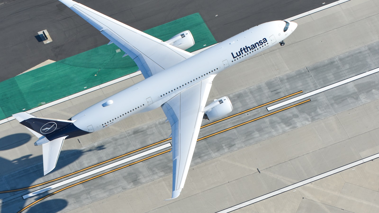 a large passenger jet flying over a runway