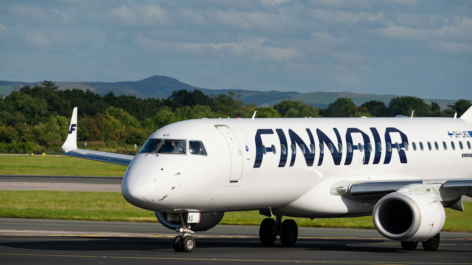 A finnair airplane on a runway at an airport
