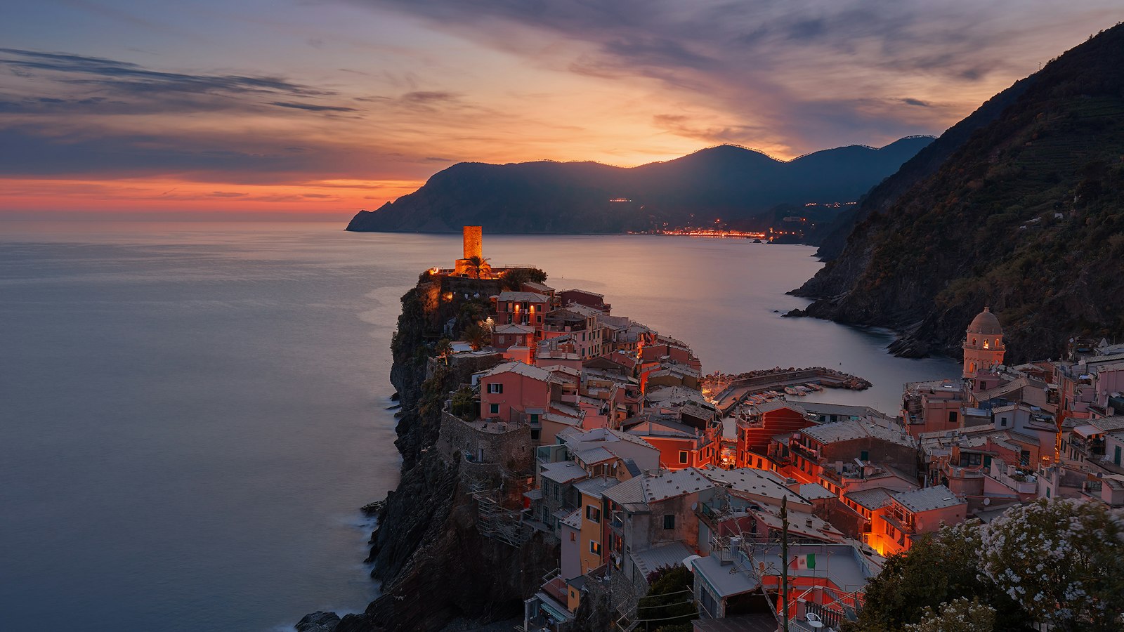 The coastal village of Vernazza in Italy under a warm orange sky