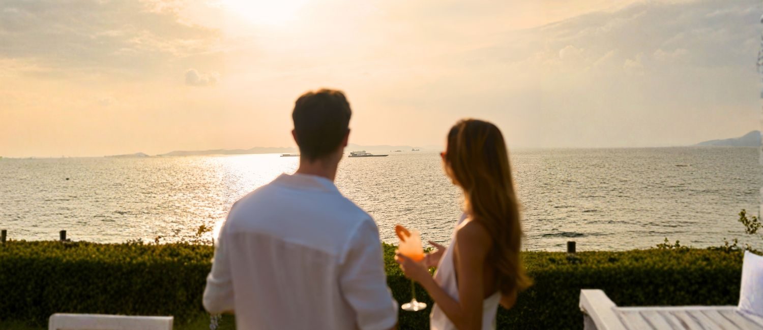 Photo of a couple enjoying the sunset at a Dusit hotel