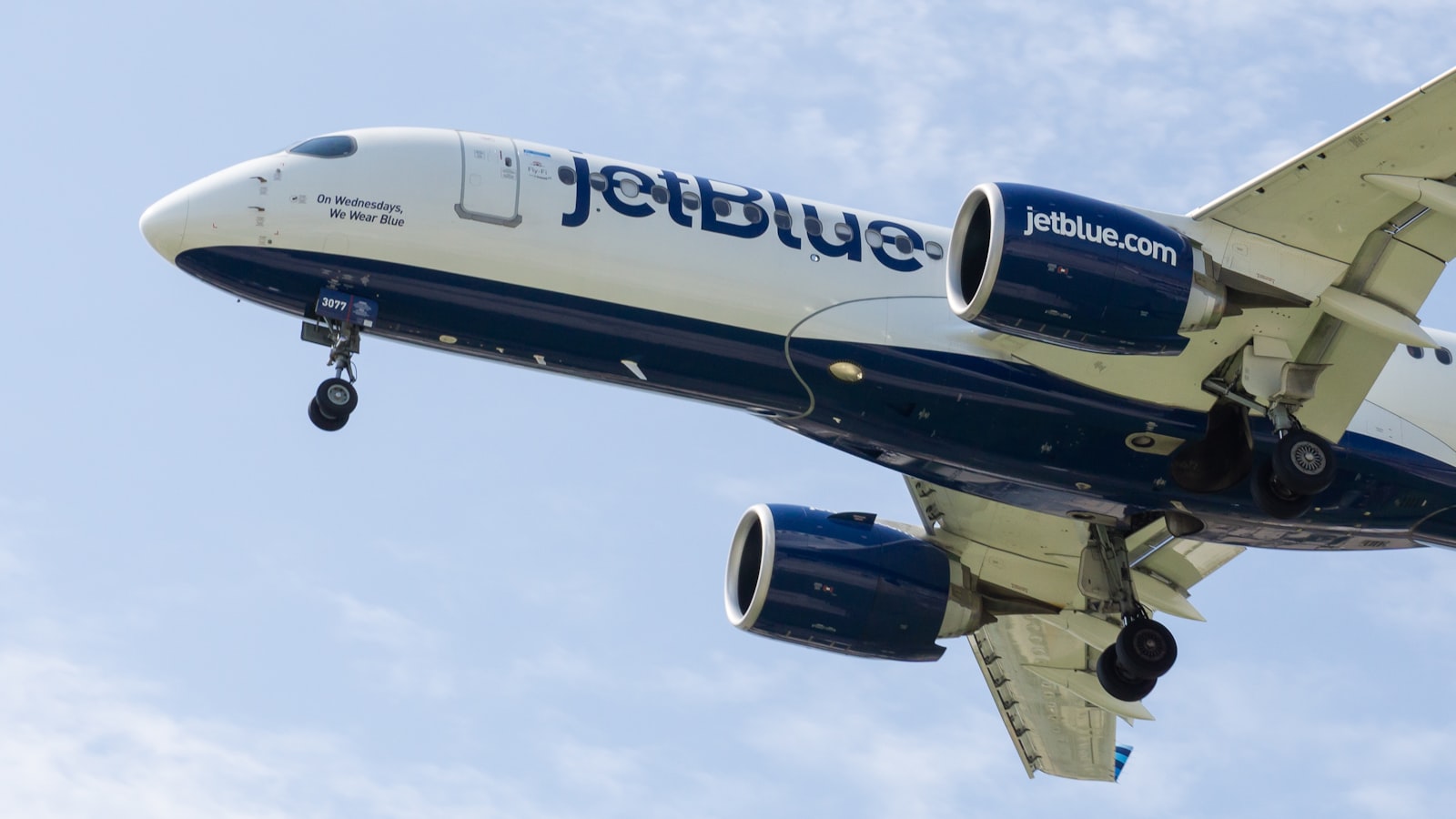 a jetblue airplane is flying in the sky