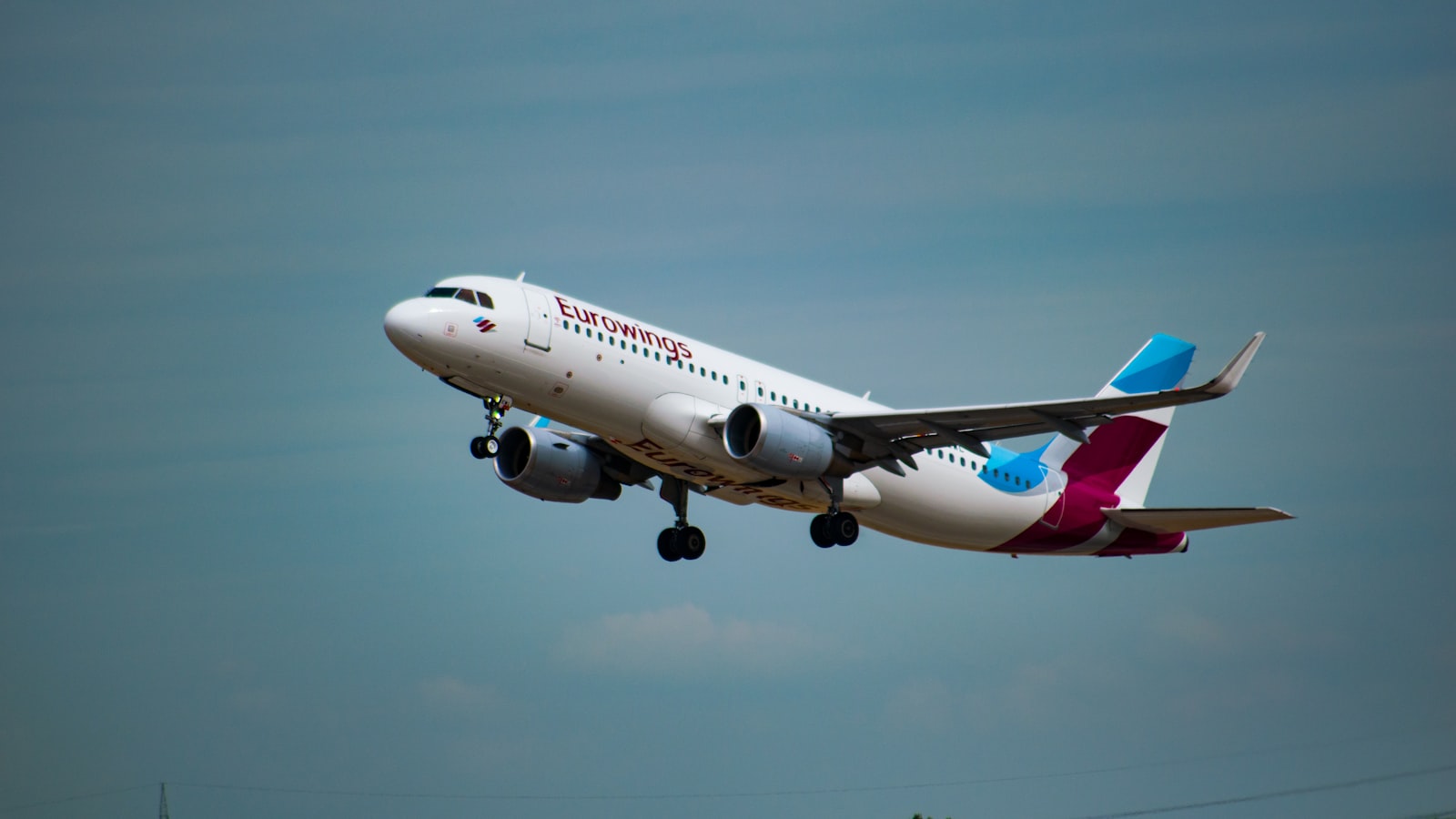 a large jetliner flying through a blue sky