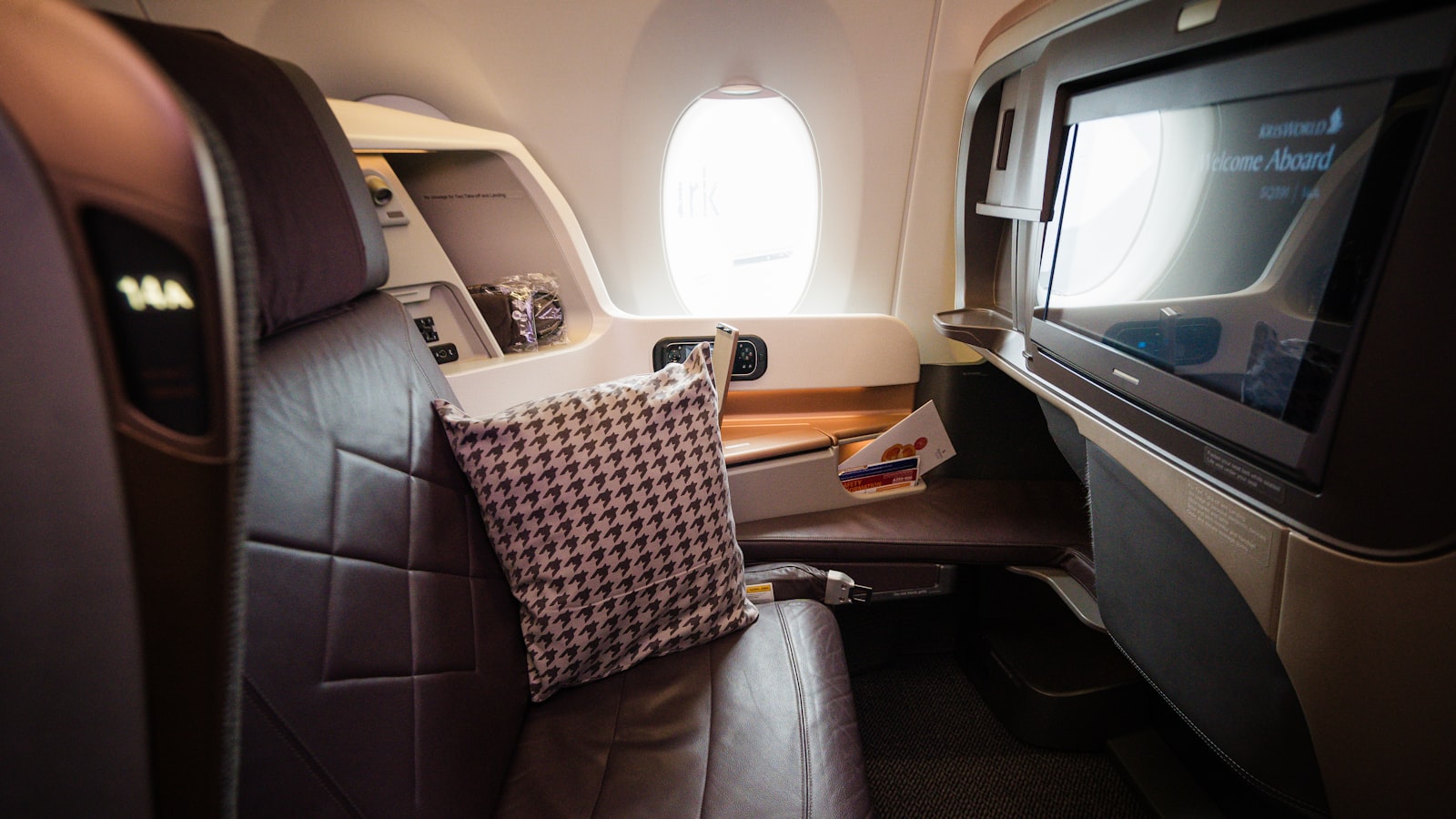 A view of the inside of an airplane with a flat screen TV