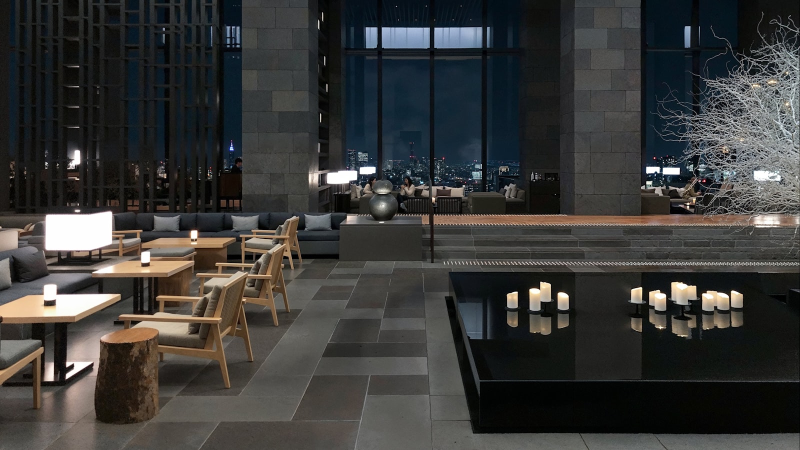 a room with tables, chairs, and candles