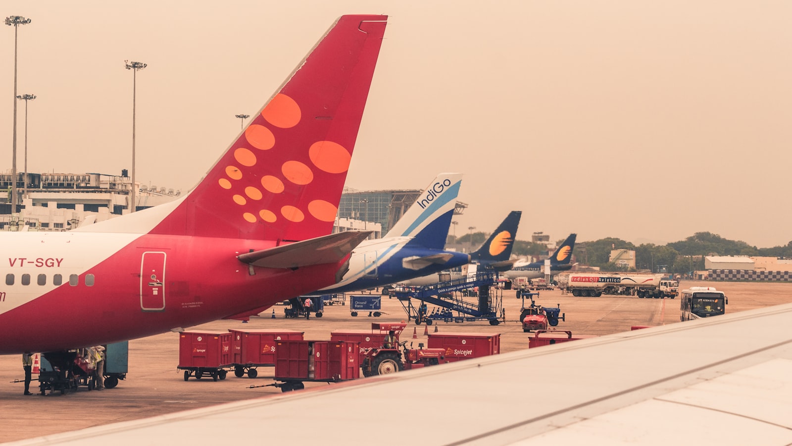four airliners parked beside airport