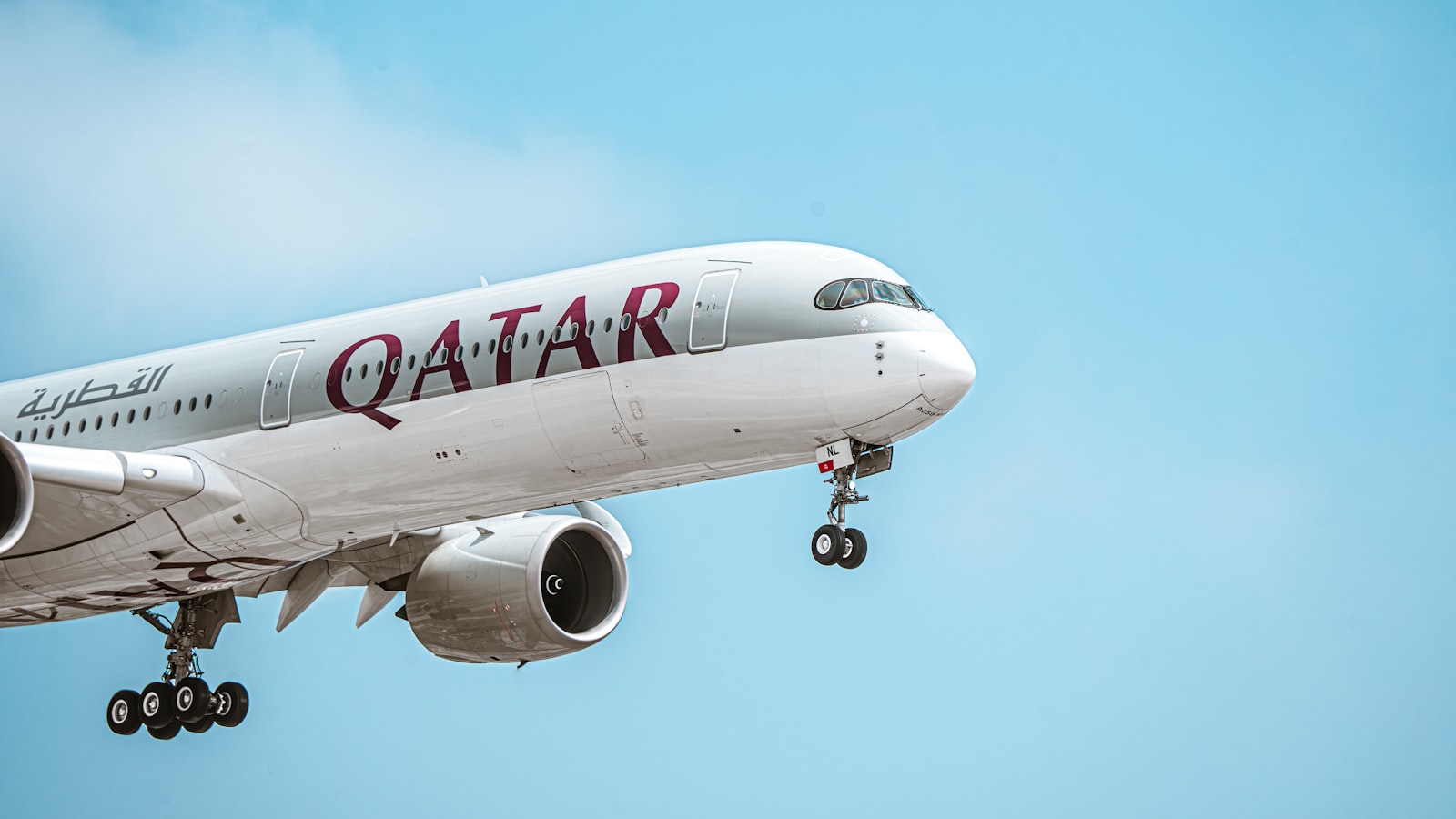 a large jetliner flying through a blue sky