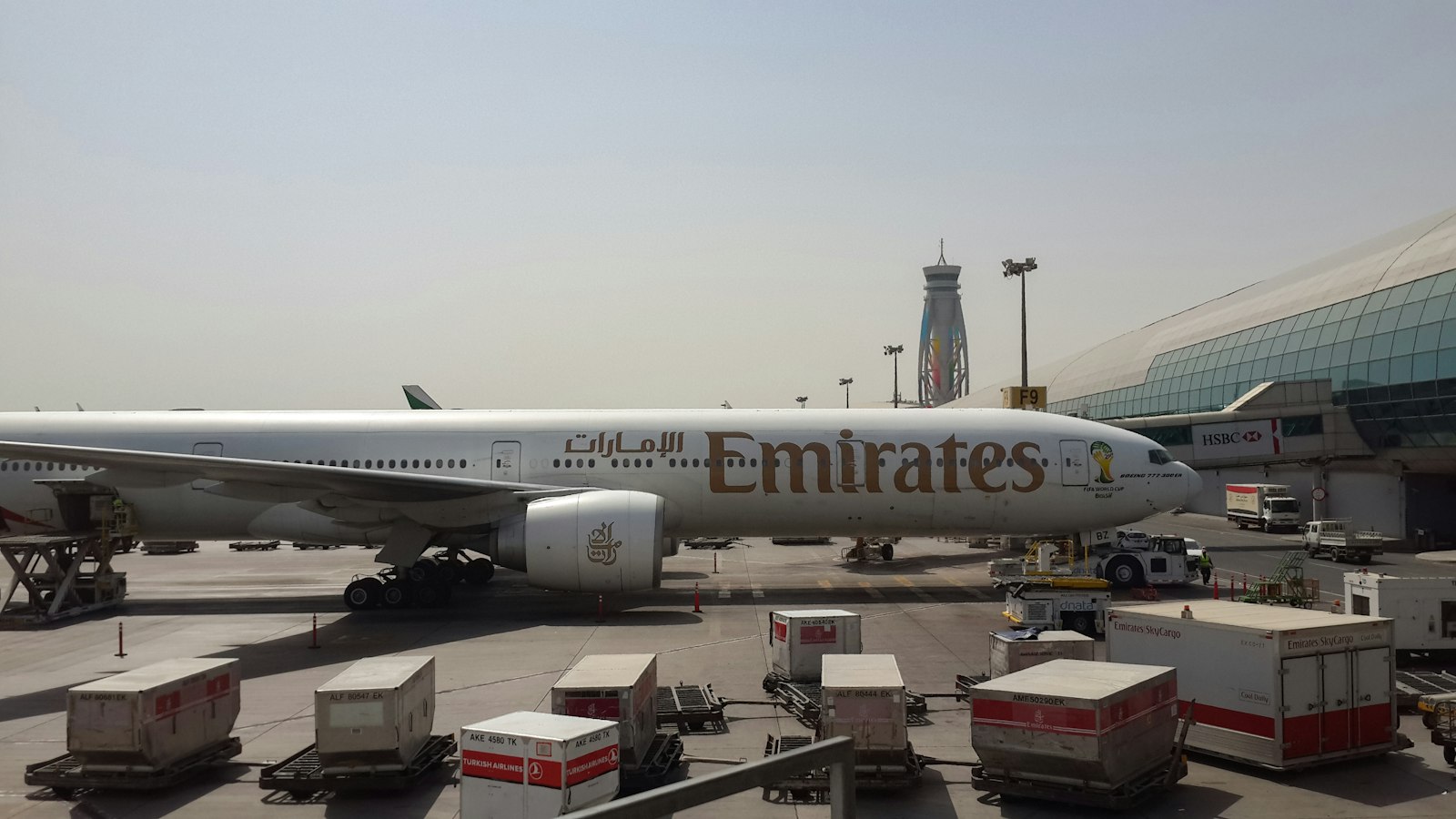 a large Emirates jetliner sitting on top of an airport tarmac
