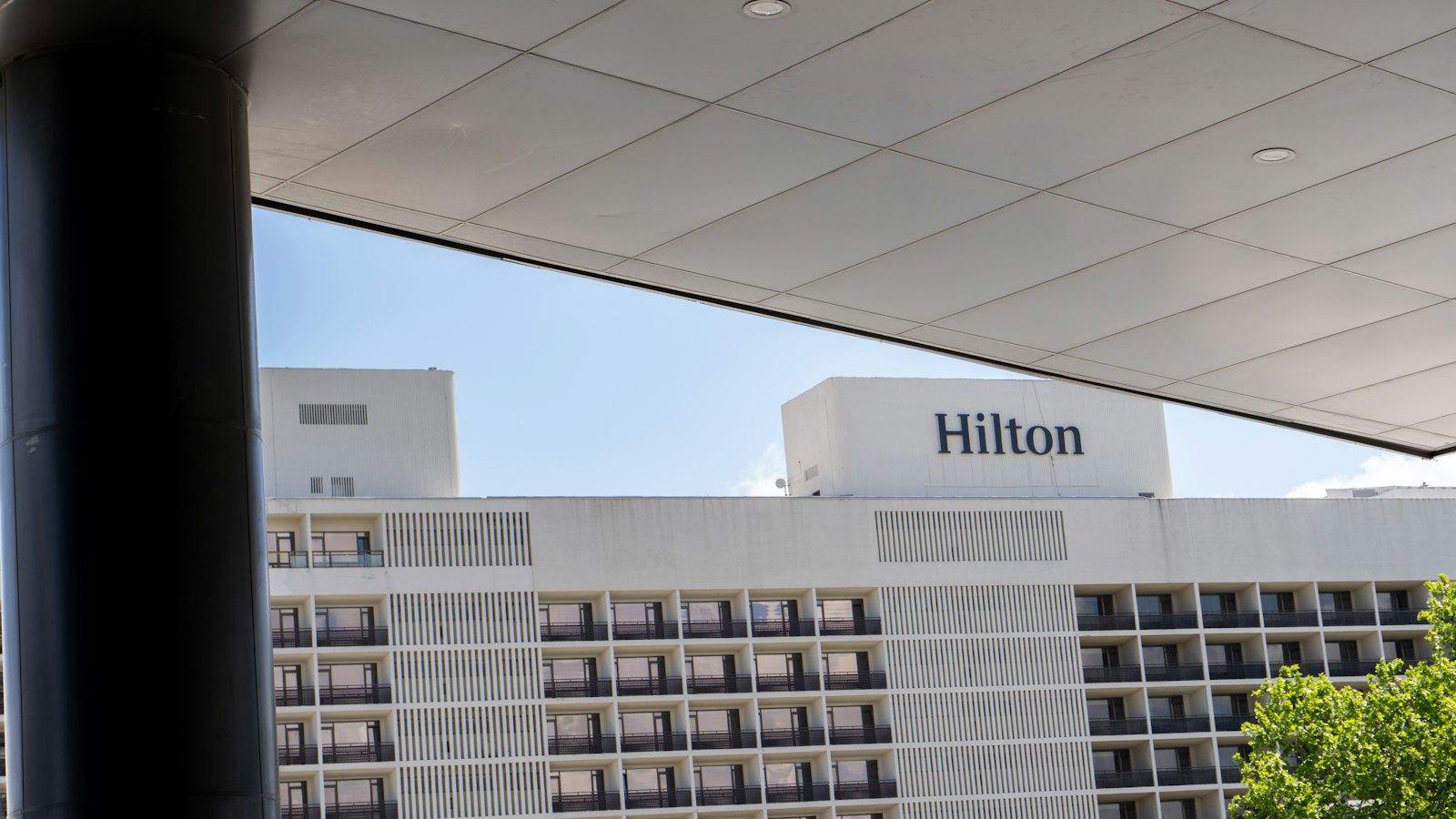 A hotel with a large white building in the background