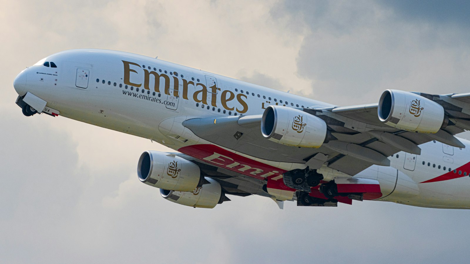 white and red passenger plane in the sky