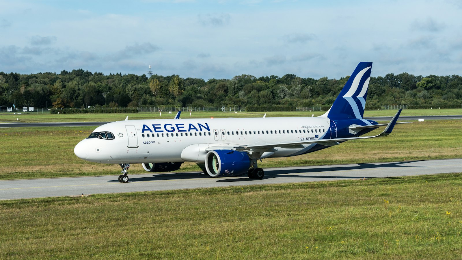 An aegean airlines plane is on a runway