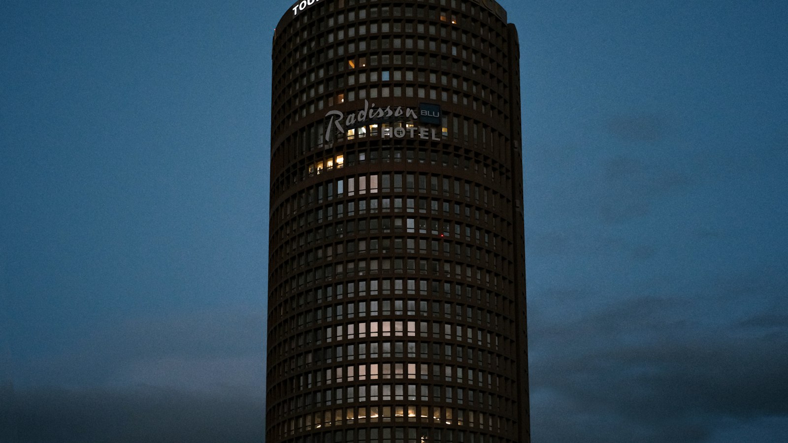 A very tall building with a clock on it's side